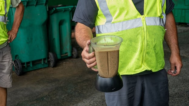 Save That Stuff Founder Erik Levy holding a blender of engineered bioslurry (EBS) inside the CORe Facility.